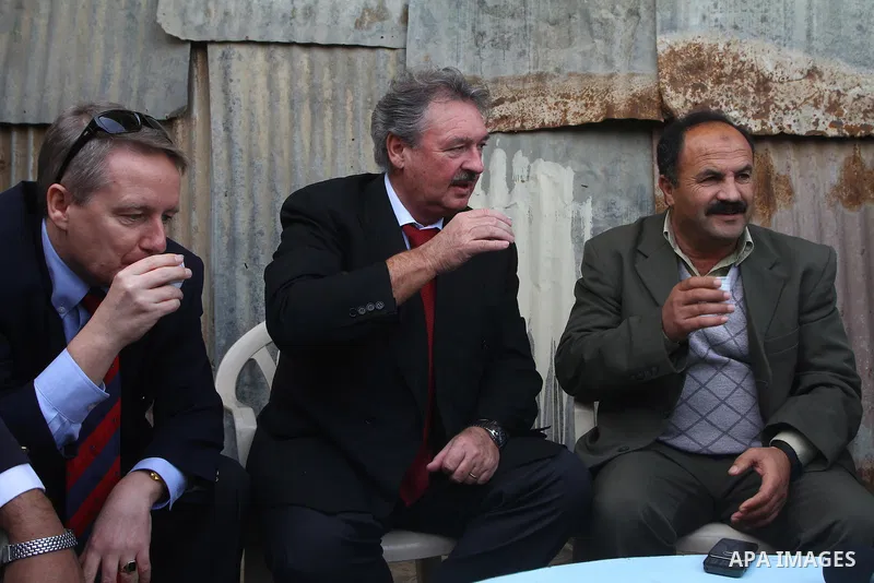 Luxembourg's Foreign Minister Jean Asselborn, drinks an Arabic coffee while he meets Palestinian fishermen during his tour to the Gaza fishermen port in Gaza City, Friday, Feb. 25, 2011. Asselborn is on an official visit...