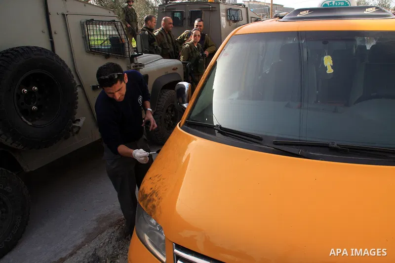 An Israeli soldier guards as a damaged car in the village of Jeet the West bank city of Qalqilya, Friday,25, 2011. Palestinians and the Israeli military said Friday Jewish settlers vandalized in a Palestinian village in...