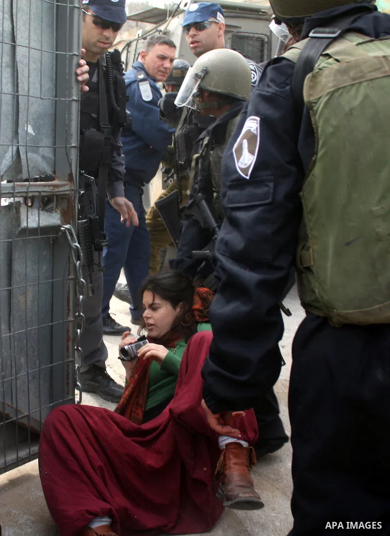 Israeli police officers try to push back Palestinian, Israeli and foreign activists during a protest against the continued closure of Shuhada street to Palestinians, in the West Bank city of Hebron 25 February 2011. The...