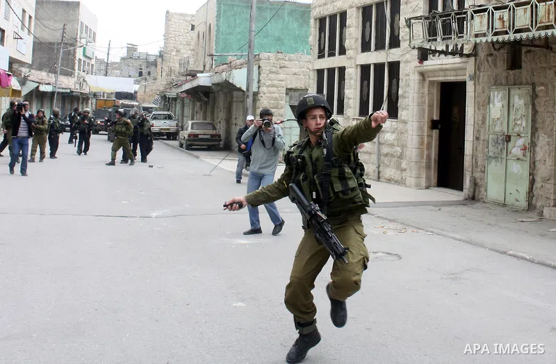 Israeli police officers try to push back Palestinian, Israeli and foreign activists during a protest against the continued closure of Shuhada street to Palestinians, in the West Bank city of Hebron 25 February 2011. The...