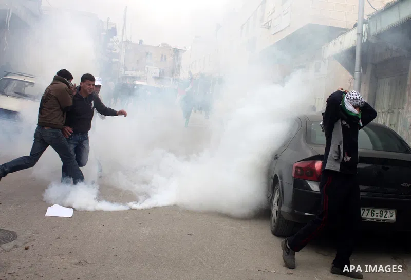 Palestinian, Israeli and foreign activists take part in a protest against the continued closure of Shuhada street to Palestinians, in the West Bank city of Hebron 25 February 2011. The activists gathered on Friday callin...