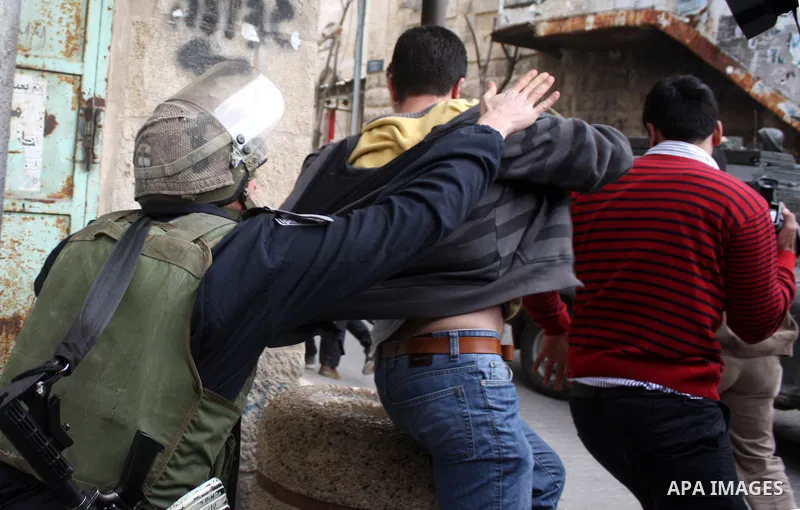 Israeli police officers try to push back Palestinian, Israeli and foreign activists during a protest against the continued closure of Shuhada street to Palestinians, in the West Bank city of Hebron 25 February 2011. The...