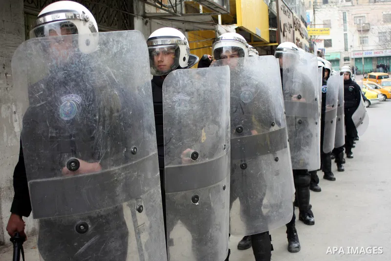 Palestinian riot-police take positions to prevent clashes between Palestinian protesters and Israeli security forces, not pictured, during a demonstration against the closure of Shuhada street to Palestinians, in the Wes...