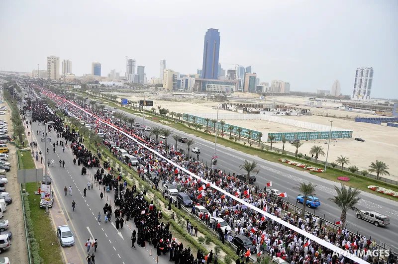 Protesters march on the streets of Manama, Bahrain, 25 February 2011. Tens of thousands of protesters marched in the Bahraini capital of Manama on 25 February to demand the resignation of the cabinet. It was the latest i...