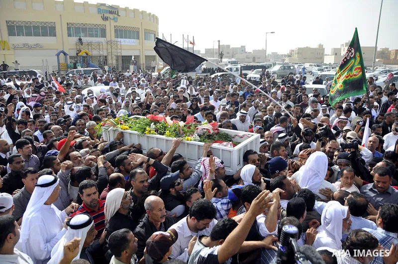 Anti-monarchy protesters and relatives accompany the coffin with the corpse of protester Abdul Redha Mohammed Hassan, 32, who was shot in the head by security forces while trying to march to Pearl Square, during the buri...