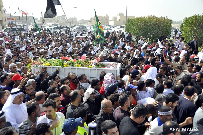 Anti-monarchy protesters and relatives accompany the coffin with the corpse of protester Abdul Redha Mohammed Hassan, 32, who was shot in the head by security forces while trying to march to Pearl Square, during the buri...