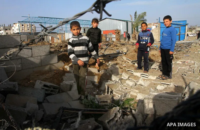Palestinian boys inspect the damage left after a missile fired from an Israeli warplane hit Nusairat refugee camp, Central Gaza strip, Saturday, Feb. 26, 2011. The Israeli airforce attacked Friday night several targets i...