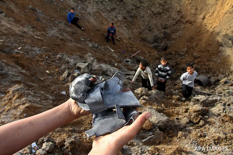 Palestinian boys inspect the damage left after a missile fired from an Israeli warplane hit Nusairat refugee camp, Central Gaza strip, Saturday, Feb. 26, 2011. The Israeli airforce attacked Friday night several targets i...