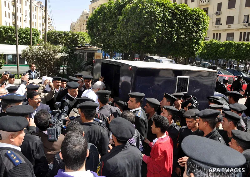 Amr Assal, the former head of industrial authority wears white prison uniform as he enters the police car just outside Cairo Criminal Court in Cairo, Egypt, Saturday, Feb. 26, 2011. Photo by Ahmed Asad
