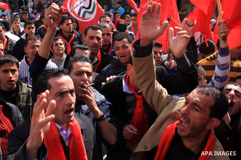 Palestinian supporters of the Palestinian Peoples Party (PPP) shout slogans during a rally in the centre of the West Bank city of Nablus demanding an end to the split between the Gaza Strip and the West Bank and calling...