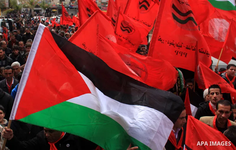 Palestinian supporters of the Palestinian Peoples Party (PPP) wave party flags as they rally in the centre of the West Bank city of Nablus demanding an end to the split between the Gaza Strip and the West Bank and callin...