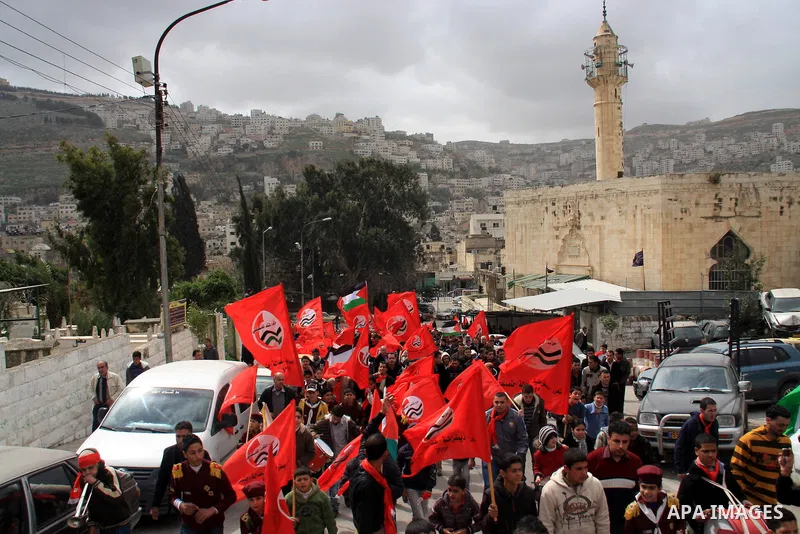 Palestinian members of Palestinian Peoples Party (PPP) wave party flags as they rally in the centre of the West Bank city of Nablus demanding an end to the split between the Gaza Strip and the West Bank and calling for p...