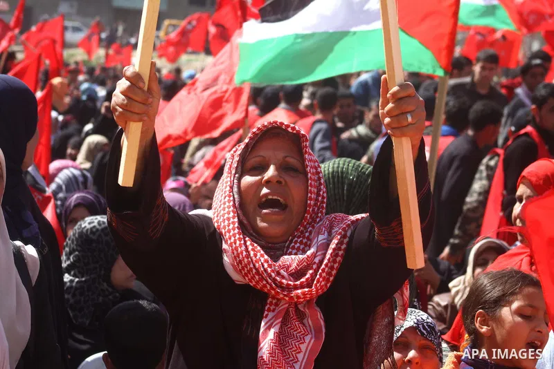 A Palestinian supporter of the Democratic Front for the Liberation of Palestine (DFLP) carries flag during a rally celebrating 42 years since its founding in Gaza City, Saturday, Feb. 26, 2011. Founded in 1969 the DFLP i...
