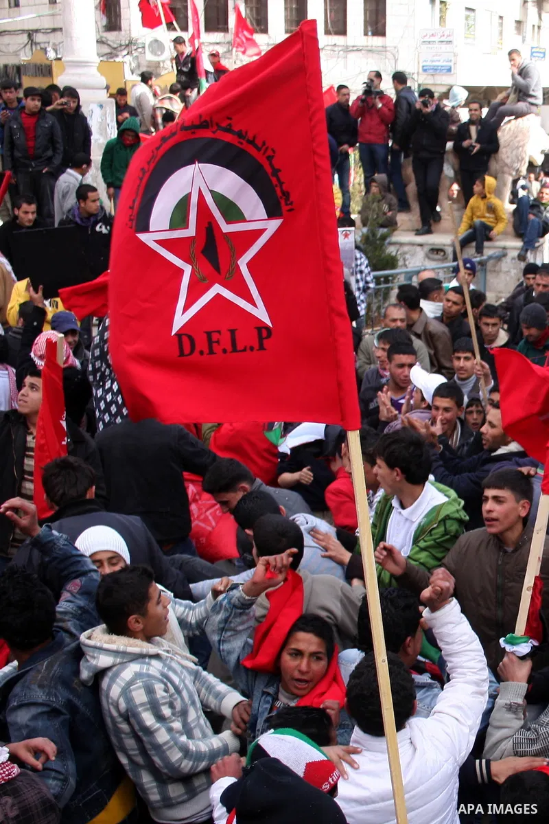 Palestinian supporters of the Democratic Front for the Liberation of Palestine (DFLP) carry flags during a rally celebrating 42 years since its founding in the West Bank city of Ramallah, Saturday, Feb. 26, 2011. Founded...