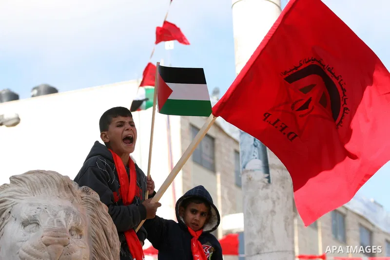 Palestinian supporters of the Democratic Front for the Liberation of Palestine (DFLP) carry flags during a rally celebrating 42 years since its founding in the West Bank city of Ramallah, Saturday, Feb. 26, 2011. Founded...