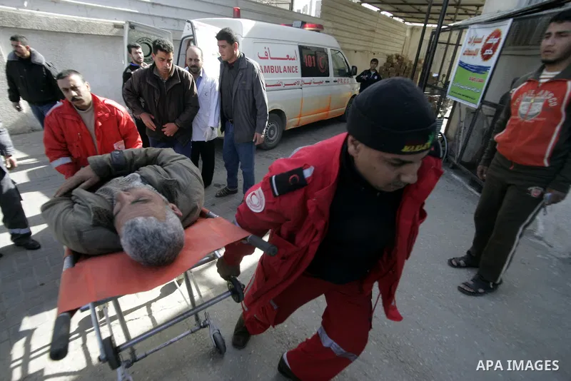 A Palestinian man is wheeled to the hospital after he was wounded in Israeli air raid, in the southern Gaza Strip town of Rafah, on Feb. 26, 2011. Israeli aircraft attacked two military sites of the armed wing of the Isl...