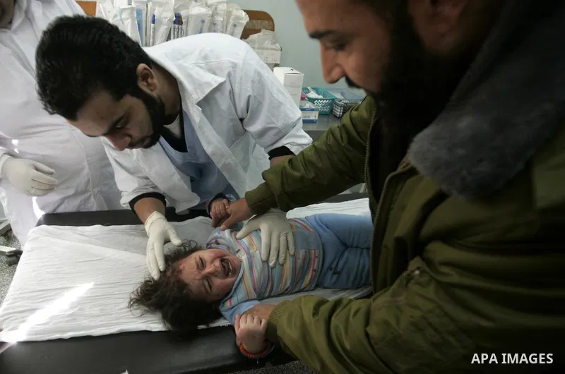 A Palestinian girl cries as she receives a treatment after she was wounded in Israeli air raid, at a hospital in the southern Gaza Strip town of Rafah, on Feb. 26, 2011. Israeli aircraft attacked two military sites of th...