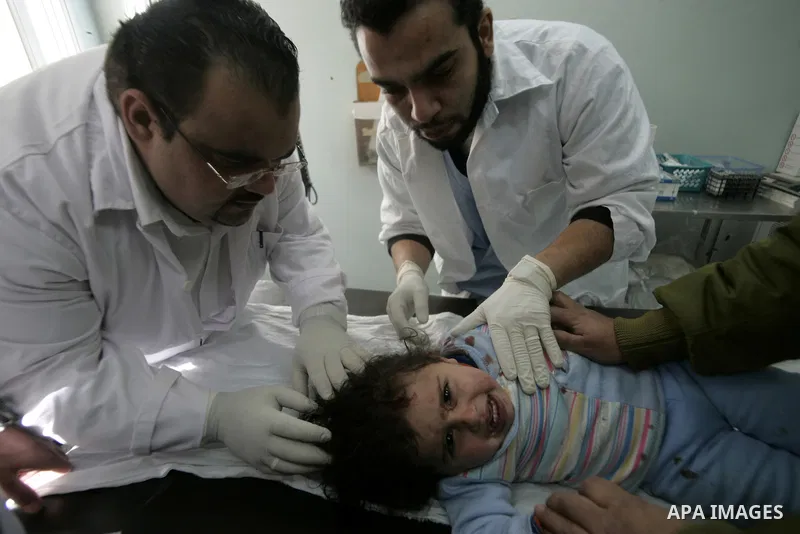 A Palestinian girl cries as she receives a treatment after she was wounded in Israeli air raid, at a hospital in the southern Gaza Strip town of Rafah, on Feb. 26, 2011. Israeli aircraft attacked two military sites of th...