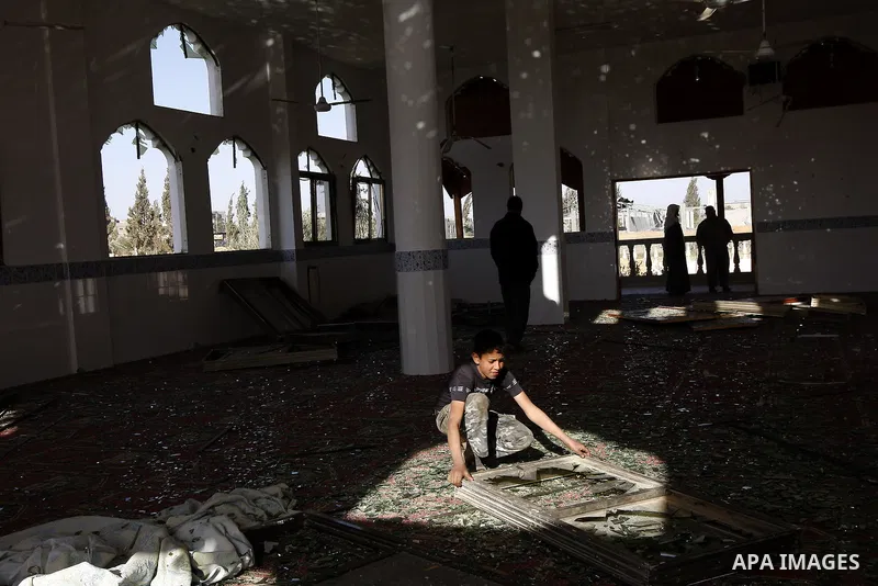 Palestinians inspect the damage to a mosque at the scene of an Israeli air strike in Rafah, southern Gaza Strip on February 26, 2011. Israeli warplanes bombed two training camps of the Islamic Jihad group in the Gaza Str...