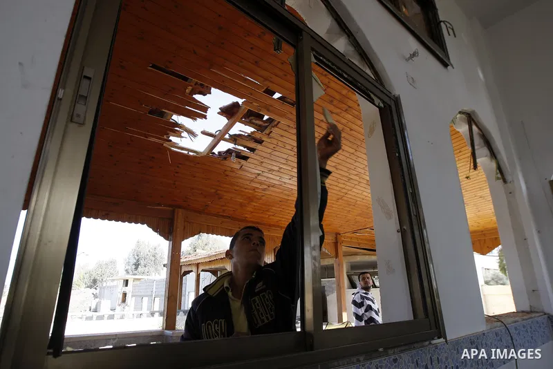 Palestinians inspect the damage to a mosque at the scene of an Israeli air strike in Rafah, southern Gaza Strip on February 26, 2011. Israeli warplanes bombed two training camps of the Islamic Jihad group in the Gaza Str...