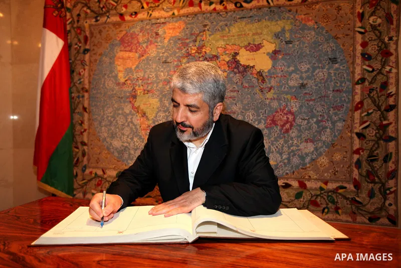 Palestinian Hamas leader Khaled Meshaal, writing notes in the book of the ministry of foreign affairs of Oman, in Sultanate of Oman on Feb. 26, 2011. Photo by Majd Majd