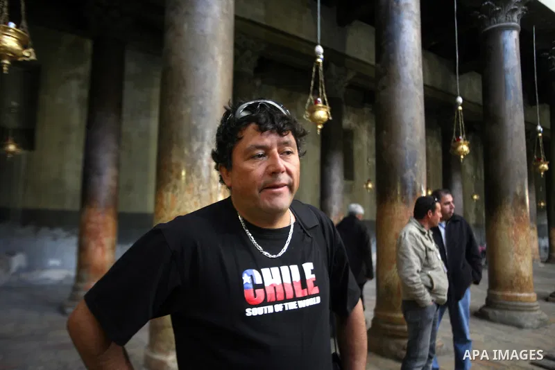 A member of Chilean miners who were rescued after 69 days of trapping underground in a collapsed mine in San Jose, visits the Church of the Nativity, the site revered as the birthplace of Jesus, in the West Bank city of...