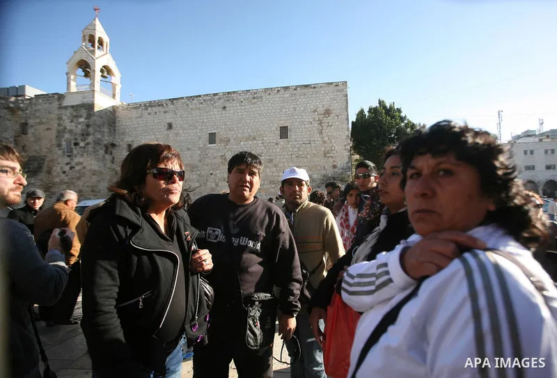 Chilean miners who were rescued after 69 days of trapping underground in a collapsed mine in San Jose, visit the Church of the Nativity, the site revered as the birthplace of Jesus, in the West Bank city of Bethlehem, on...