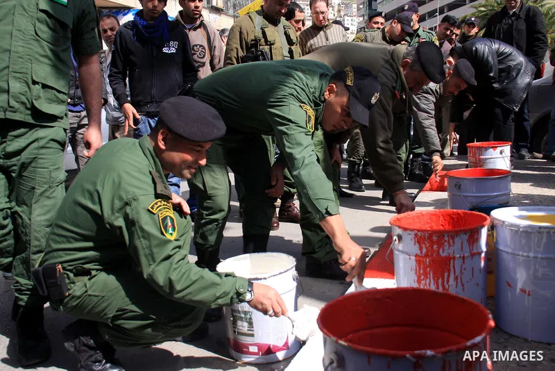Palestinian national security forces paint the streets in the center of the city of Nablus in the West Bank, Sunday, Feb. 27, 2011. Photo by Wagdi Eshtayah