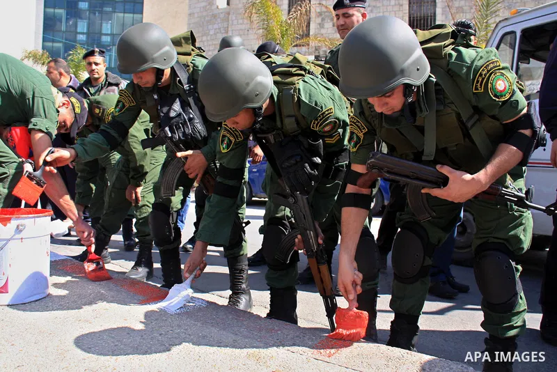 Palestinian national security forces clean up garbage and paint the street in the center of the city of Nablus in the West Bank, Sunday, Feb. 27, 2011. Photo by Wagdi Eshtayah
