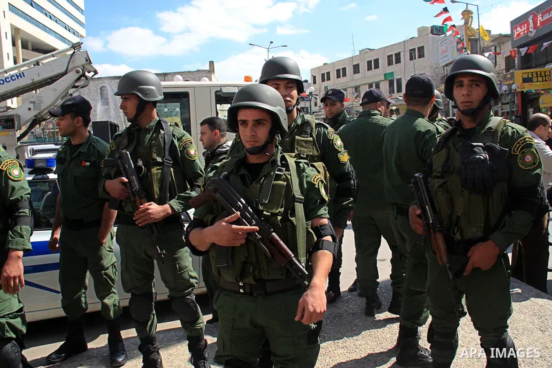 Palestinian national security forces stand guards during campaign to clean up and paint the streets, in the center of the city of Nablus in the West Bank, Sunday, Feb. 27, 2011. Photo by Wagdi Eshtayah
