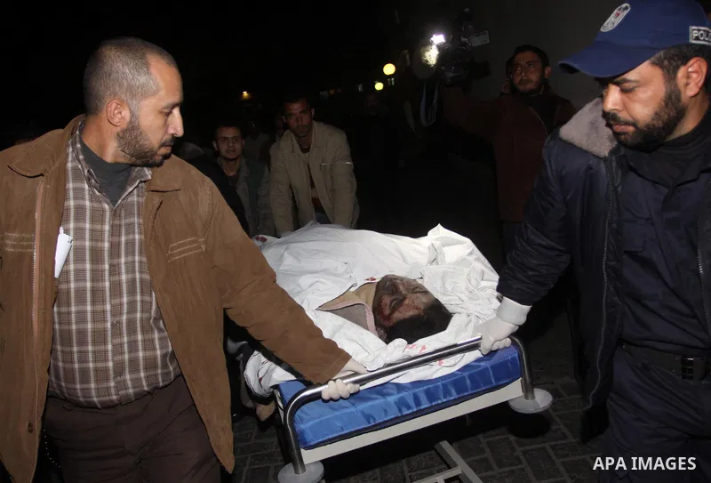 Palestinians gather around the body of a man at the mortuary of Al-Shifa hospital in Gaza City on February 27, 2011 after he was killed when an Israeli tank opened fire on a group of militants, medical sources and witnes...