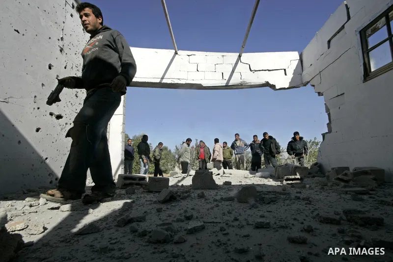 Palestinians inspect a house bombed by Israeli artillery, in the southern Gaza Strip town of Rafah on February 28, 2011. A Palestinian laborer was injured who was collecting gravel near the airport, while the family mira...