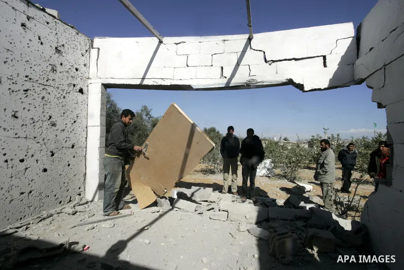 Palestinians inspect a house bombed by Israeli artillery, in the southern Gaza Strip town of Rafah on February 28, 2011. A Palestinian laborer was injured who was collecting gravel near the airport, while the family mira...