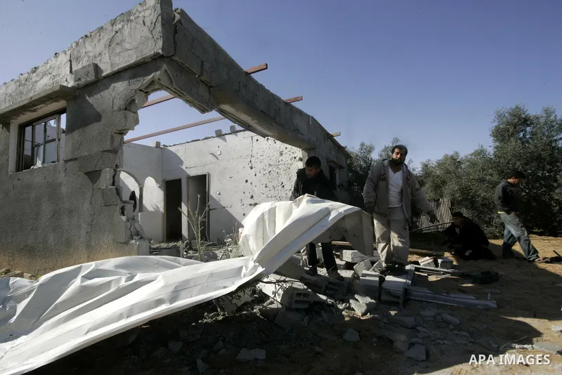 Palestinians inspect a house bombed by Israeli artillery, in the southern Gaza Strip town of Rafah on February 28, 2011. A Palestinian laborer was injured who was collecting gravel near the airport, while the family mira...