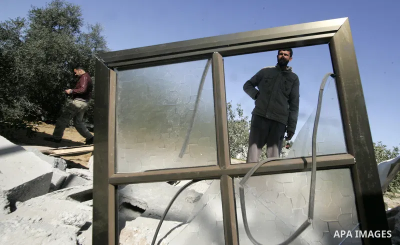 Palestinians inspect a house bombed by Israeli artillery, in the southern Gaza Strip town of Rafah on February 28, 2011. A Palestinian laborer was injured who was collecting gravel near the airport, while the family mira...
