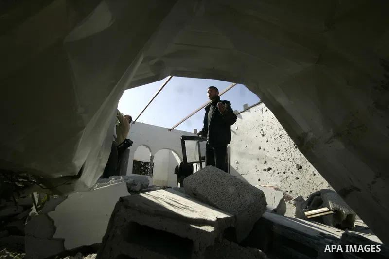 Palestinians inspect a house bombed by Israeli artillery, in the southern Gaza Strip town of Rafah on February 28, 2011. A Palestinian laborer was injured who was collecting gravel near the airport, while the family mira...