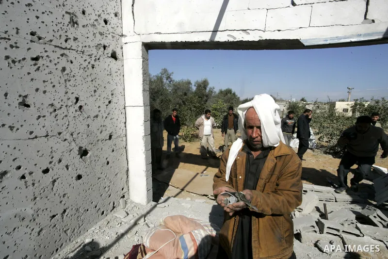 Palestinians inspect a house bombed by Israeli artillery, in the southern Gaza Strip town of Rafah on February 28, 2011. A Palestinian laborer was injured who was collecting gravel near the airport, while the family mira...