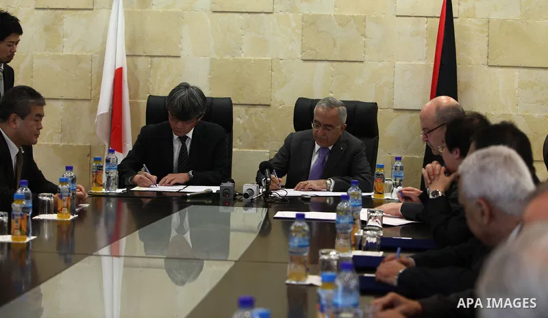 Palestinian prime minister Salam Fayyad, signs a project convention to establish a collection system and wastewater treatment in Jericho with the Japanese government, in the West Bank City of Ramallah on Feb. 28, 2011. P...