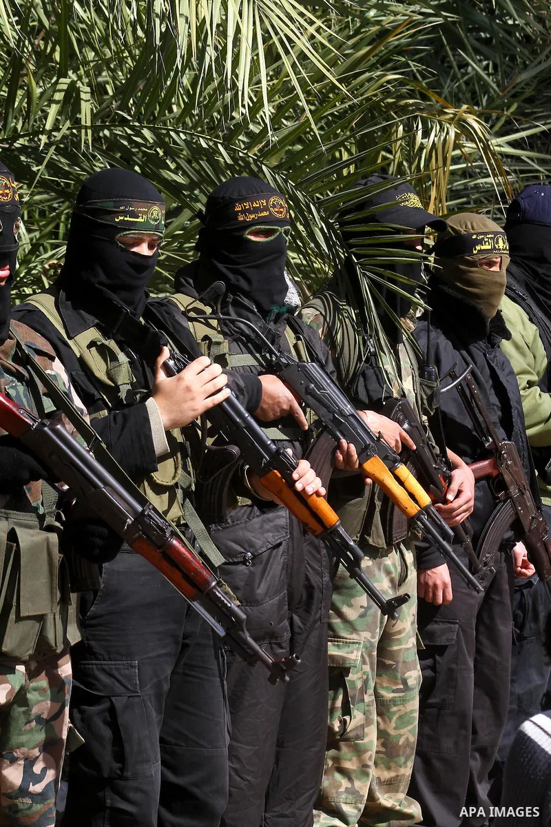 Masked Islamic Jihad militants wait next to the family house of Abeed Shaheen, killed by Israeli shell on Sunday, in Deir al-Balah refugee camp, central Gaza Strip, Monday, Feb. 28, 2011. Photo by Ashraf Amra