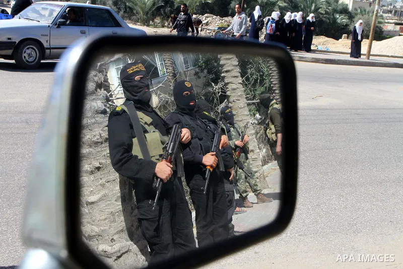 Masked Islamic Jihad militants wait next to the family house of Abeed Shaheen, killed by Israeli shell on Sunday, in Deir al-Balah refugee camp, central Gaza Strip, Monday, Feb. 28, 2011. Photo by Ashraf Amra