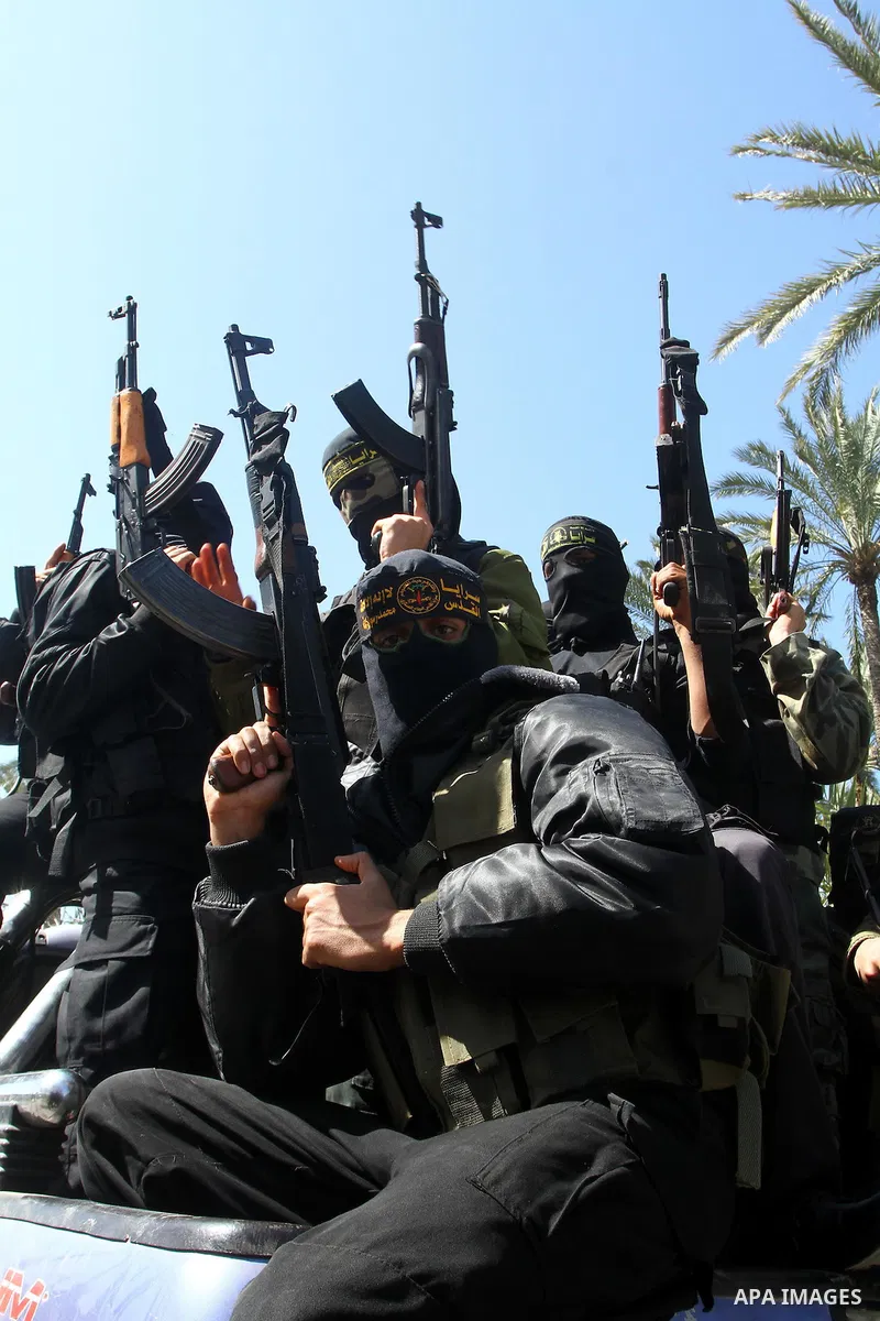 Masked Islamic Jihad militants wait next to the family house of Abeed Shaheen, killed by Israeli shell on Sunday, in Deir al-Balah refugee camp, central Gaza Strip, Monday, Feb. 28, 2011. Photo by Ashraf Amra