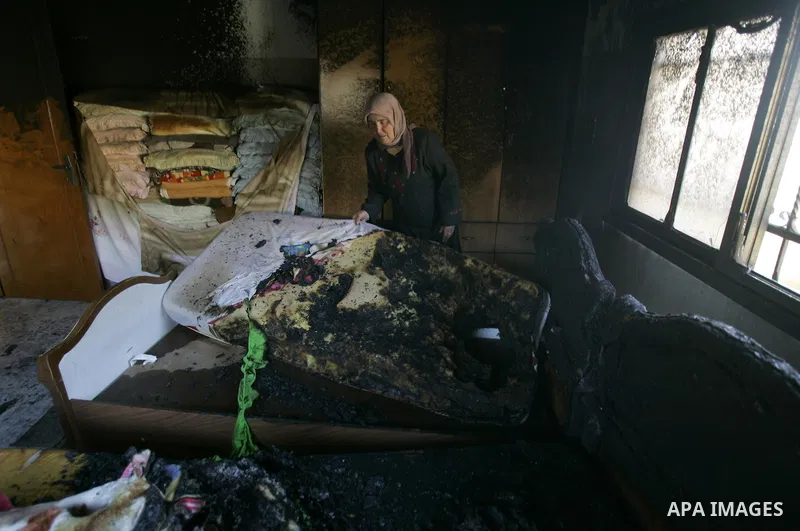 A Palestinian woman looks at a burnt room after her family house was firebombed by Jewish settlers overnight in the West Bank village of Huwwara near Nablus, on March 01, 2011 causing two children to be taken to hospital...