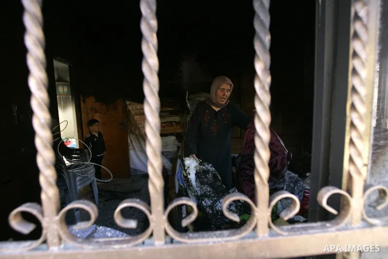A Palestinian woman looks at a burnt room after her family house was firebombed by Jewish settlers overnight in the West Bank village of Huwwara near Nablus, on March 01, 2011 causing two children to be taken to hospital...