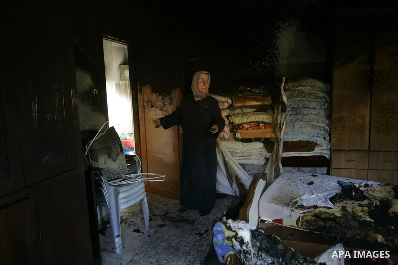 A Palestinian woman looks at a burnt room after her family house was firebombed by Jewish settlers overnight in the West Bank village of Huwwara near Nablus, on March 01, 2011 causing two children to be taken to hospital...