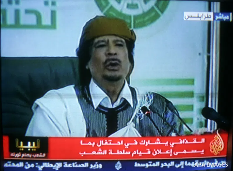 A picture taken from Qatar Al Jazeera state television on March 02, 2011 shows Libyan leader Moammar Qadhafi addressing to the loyalists of his regime during a public rally in Tripoli, as rebels fought back his forces ea...