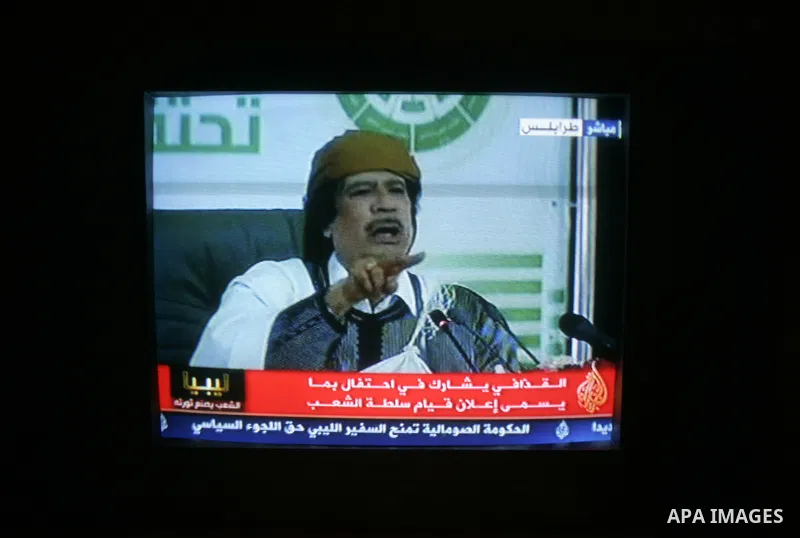 A picture taken from Qatar Al Jazeera state television on March 02, 2011 shows Libyan leader Moammar Qadhafi addressing to the loyalists of his regime during a public rally in Tripoli, as rebels fought back his forces ea...