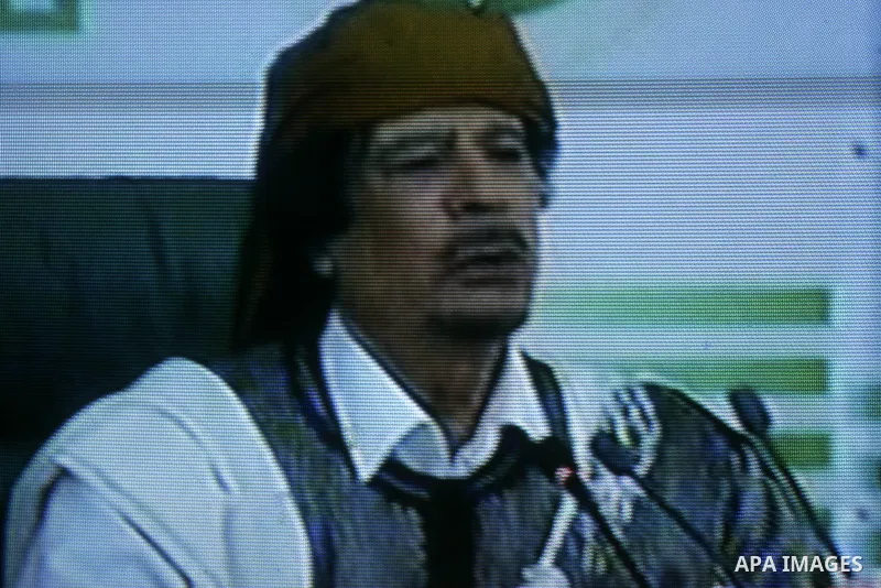 A picture taken from Qatar Al Jazeera state television on March 02, 2011 shows Libyan leader Moammar Qadhafi addressing to the loyalists of his regime during a public rally in Tripoli, as rebels fought back his forces ea...