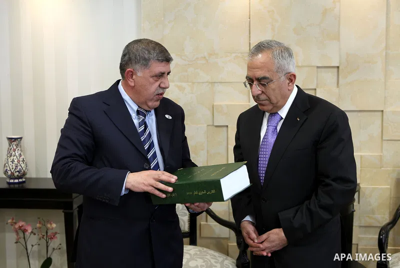 Palestinian Prime Minister, Salam Fayyad receives the report of the office of management and financial controls for 2010, in the West Bank city of Ramallah on March 2, 2011. Photo by Mustafa Abu Dayeh