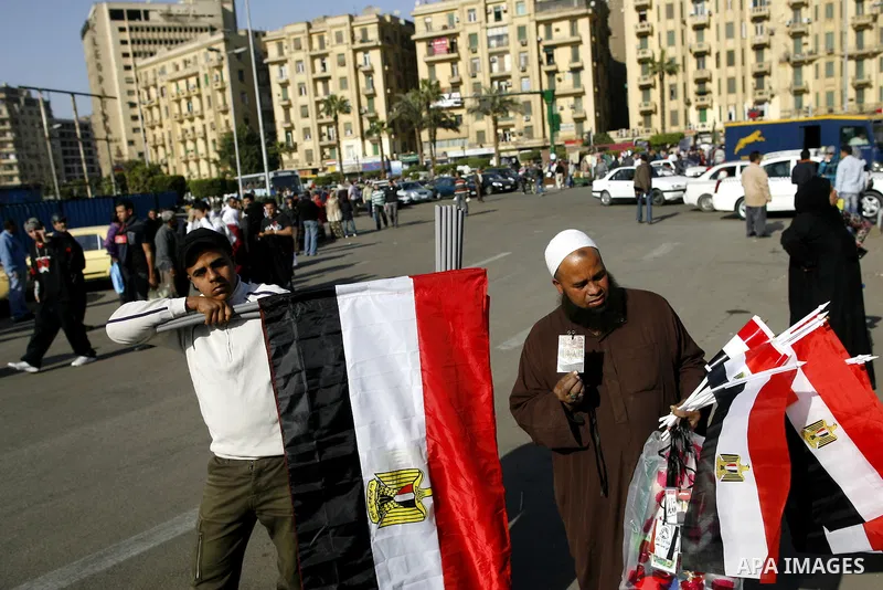Egyptian youth sells national flags at the Tahrir square in Cairo, Egypt, Thuresday, March 3, 2011. hundreds of protesters are camping at the Tahrir square in an ongoing campaign demanding the resignation of the current...