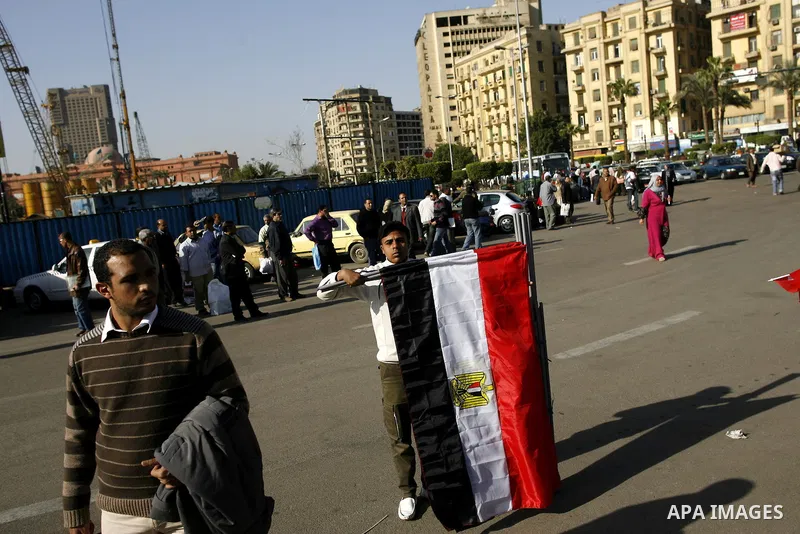 Egyptian youth sells national flags at the Tahrir square in Cairo, Egypt, Thuresday, March 3, 2011. hundreds of protesters are camping at the Tahrir square in an ongoing campaign demanding the resignation of the current...